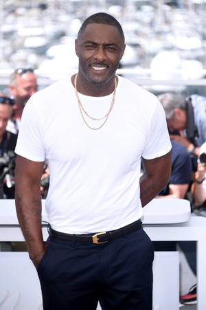 Idris Elba Against Blurry Bright Backdrop Wallpaper