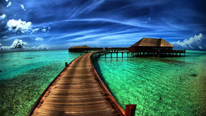 Idyllic Stilt Houses Over Calm Waters Wallpaper