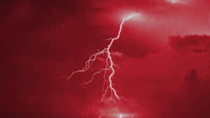Illuminating The Night Sky With Red Lightning Wallpaper