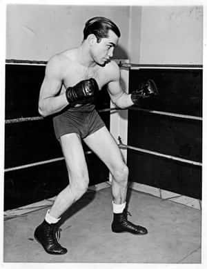 Image Barney Ross Standing Tall With A Gun Wallpaper