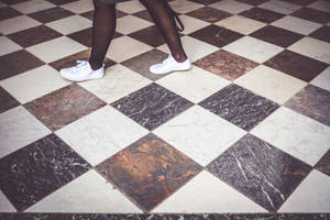 Imaginative Perspective Of A Person Standing On A Checkered Floor Wallpaper