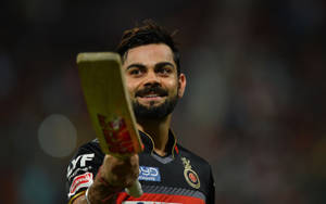 Indian Cricket Team Player Kohli In Black Uniform Wallpaper