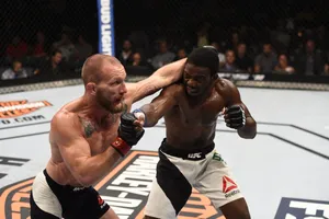 Intense Action Between Gray Maynard And Uriah Hall At A Ufc Championship Wallpaper