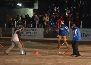 Intense Broomball Match With Blue And White Teams Wallpaper