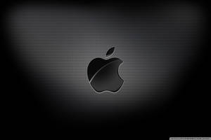 Intriguing Display Of Apple Logo In 4k Resolution On A Black Carbon Texture. Wallpaper