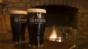 Irish Dry Stout Guinness Near Fireplace Wallpaper