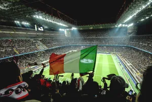 Italian Football Match At Stadium With Flag Wallpaper