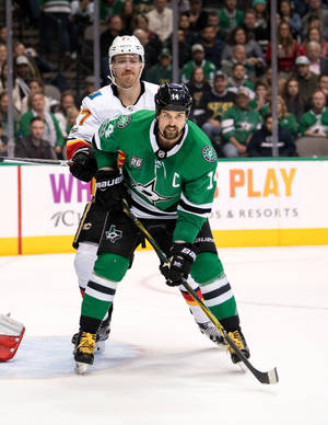 Jamie Benn Being Held Against An Opposing Player Wallpaper