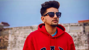 Jass Manak Stylishly Posing In Trendy Red Hoodie. Wallpaper