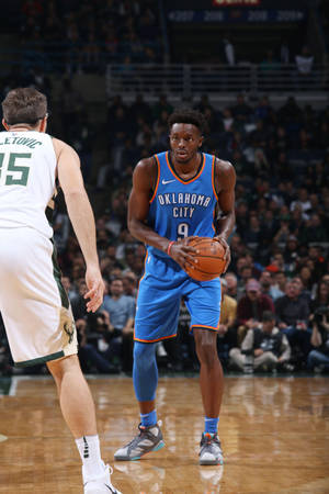 Jerami Grant Holding A Ball Wallpaper