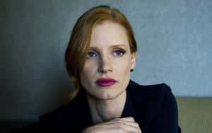 Jessica Chastain Striking A Pose In Stylish Attire Wallpaper