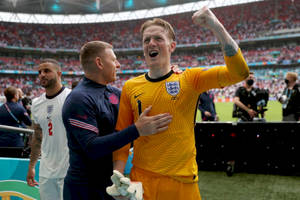 Jordan Pickford Celebrating In Yellow Uniform Wallpaper