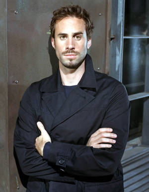 Joseph Fiennes Posing In A Black Raincoat Wallpaper