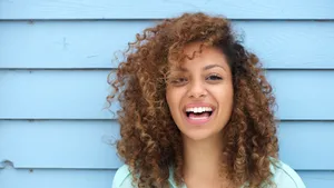 Joyful African Woman Embracing Happiness Wallpaper