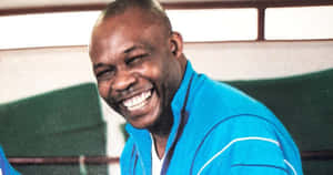 Joyful_ Man_ Laughing_in_ Blue_ Top.jpg Wallpaper