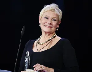 Judy Dench With A Trophy Wallpaper