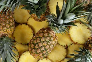 Juicy Sliced And Whole Pineapples Wallpaper