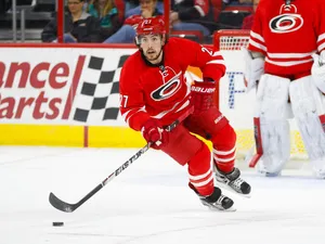 Justin Faulk In Action In Red Uniform Wallpaper