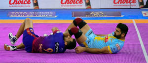 Kabaddi Players Lying On Floor Wallpaper