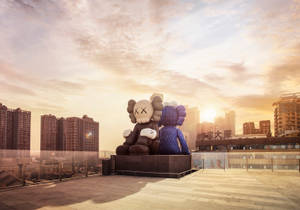 Kaws Sculpture Under Sunset Wallpaper