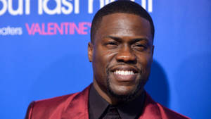 Kevin Hart In Red Suit Wallpaper