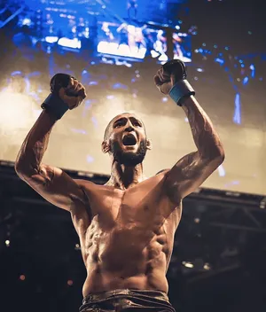 Khamzat Chimaev In Front Of Screen Wallpaper