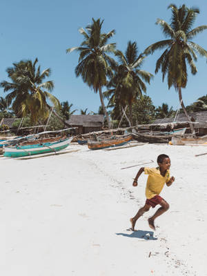 Kids Playing By Madadascar Beach Wallpaper