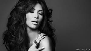Kim Kardashian Striking A Signature Pose Wallpaper