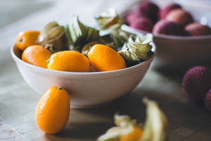 Kumquat And Lychee Fruits On Bowl Wallpaper