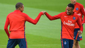 Kylian Mbappe Fist-bumping Neymar Wallpaper