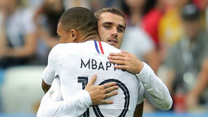 Kylian Mbappe Hugging His Teammate Wallpaper