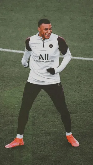 Kylian Mbappe Laughing At Field Wallpaper