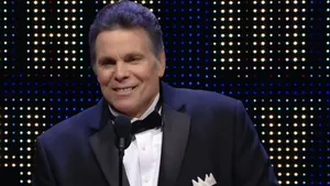Lanny Poffo Smiling In Black Suit Wallpaper