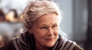 Legendary Actress Judy Dench With A Vibrant Smile Wallpaper