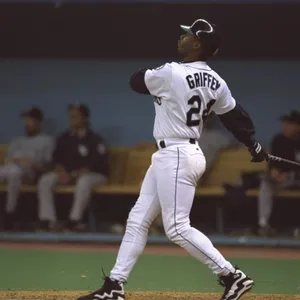 Legendary Baseball Player Ken Griffey Jr. Taking A Swing Wallpaper