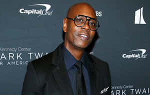 Legendary Comedian Dave Chappelle On Stage Wallpaper