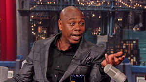 Legendary Comedian Dave Chappelle Performing Stand-up Wallpaper