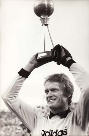 Legendary German Goalkeeper Sepp Maier Holding A Football Trophy. Wallpaper