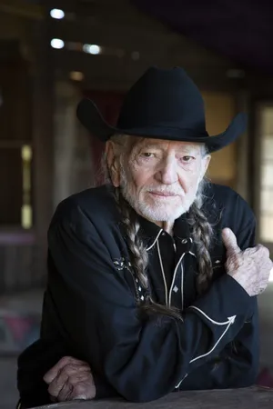Legendary Musician Willie Nelson In Classic Black Attire Wallpaper