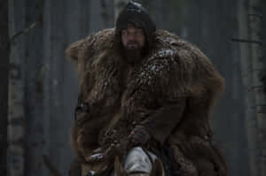 Leonardo Dicaprio In The Revenant Trudging Through Snowy Wilderness Wallpaper