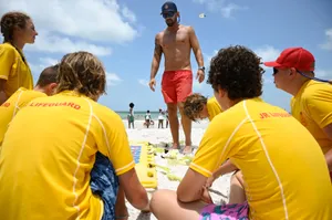Lifeguard Leading A Training Session At Junior Lifeguard Camp Wallpaper