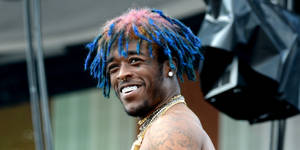 Lil Uzi Vert Serving Serious Pearly Whites. Wallpaper