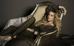 Lindsay Lohan On A Gold Chair Wallpaper