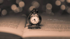 Little Watch On Open Book Tiempo Background Wallpaper