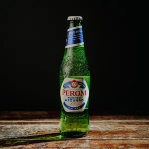 Lone Bottle Of Peroni Beer On A Black Background Wallpaper