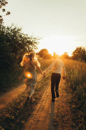 Lovers Running Towards The Sun Wallpaper