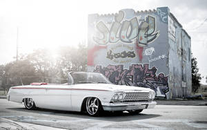 Lowrider White Impala On Outskirts Wallpaper