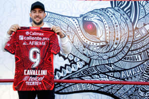 Lucas Cavallini Holding Red Soccer Jersey Wallpaper