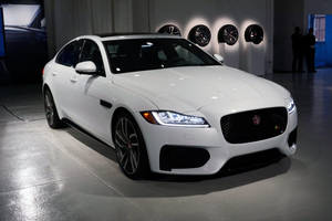 Luxurious Black And White Jaguar Car In Showroom Wallpaper