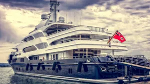 Luxurious Yacht Draped With Red Ensign Wallpaper